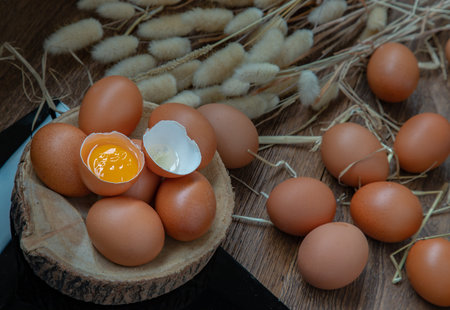 Fresh chicken egg (Hen egg) balanced on a composition of two intertwined forks with fresh chicken...