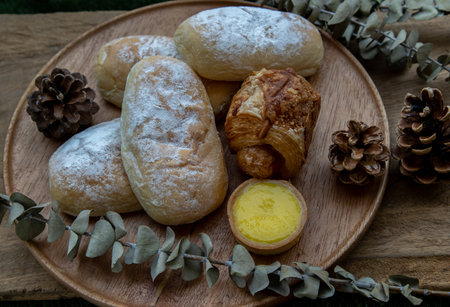 Lemon tart and Dried flowers on old rustic wooden floor. Bakery and dessert concept, Selective focus.の写真素材
