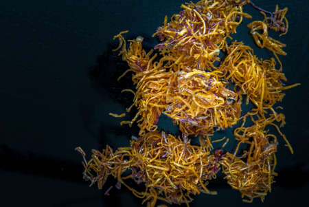 Mixed thai sweets made from sliced sweet potato coated with sugar (Potato chip) on blue table. Copy spce, Selective focus.の写真素材