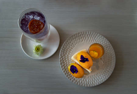 Traditional sweet dessert : Mayomgchid cheesecake on white plate, White table background. Delicious seasonal breakfast, Selective focus.の写真素材