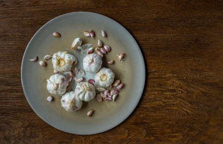 Garlic bulbs and Garlic cloves on Wooden rustic table. Copy space Concept of healthy food. Selective focus.の写真素材