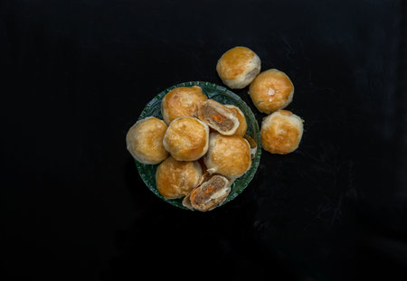 A traditional asian pastry or Tao Sor on black background. Chinese sweet pastry filled with mung...