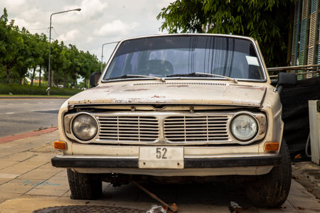Bangkok,Thailand - May 20, 2021 : Front view of broken and old vintage car were left at the road side. Selective focus.のeditorial素材