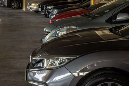 Bangkok, Thailand - 06 Jun 2021 : Close-up of Headlights and Rim of Red car. Selective focus.のeditorial素材