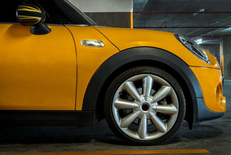 Side view of Headlights, Wheel, Hood, Sidelights and Side view mirror of Yellow car. Selective focus.のeditorial素材