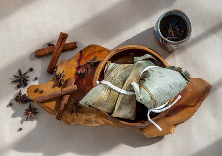 Chinese rice dumplings (Zongzi) shaped pyramidal wrapped by leaves ingredients on bowl chinese style...