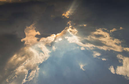 The sun shines through the clouds in the sky.  The shape of the clouds evokes imagination and creativity. They can be used as wallpapers that look amazing. Copy space, No focus, specifically.の写真素材