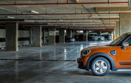 Bangkok, Thailand - 30 Jun 2021 : Side view of Headlights, Wheel, Hood, Sidelights and Side view mirror of Brown mini cooper parked in the parking lot. Selective focus.のeditorial素材