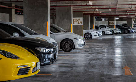 Bangkok, Thailand - 30 Jun 2021 : Side view of Headlights, Wheel, Hood, Sidelights and Side view mirror of Brown mini cooper parked in the parking lot. Selective focus.のeditorial素材