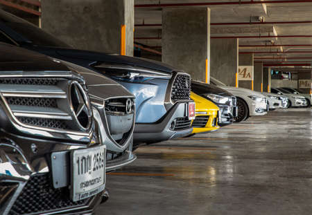 Bangkok, Thailand - 30 Jun 2021 : Row of different cars parked in Residential apartment building at workday. Full car park with parked cars. People stay at home during COVID-19 pandemic, Copy space, Selective focus.のeditorial素材