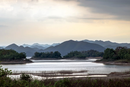 Cozy atmosphere with Evening coffee with a city view. There is a cup of coffee, diaries, notebook, pencil to record memories, Workplace area and blurry urban view, Copy space, Selective focus.の写真素材