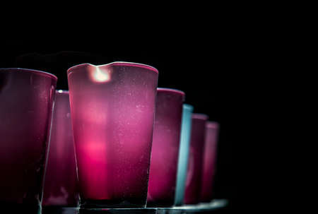 Vases for flowers are glass colored standing in a row with a perspective. Abstract glass vases color of a rainbow, Selective focus.の写真素材