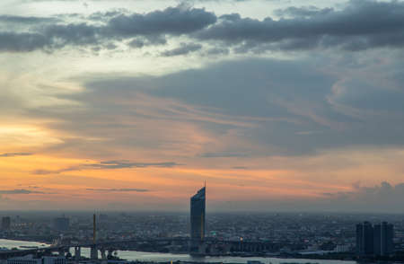Gorgeous panorama scenic of the sunrise with cloud on the orange sky over large metropolitan city in Bangkok. Copy space, Selective focus.の写真素材