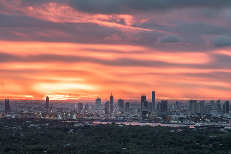 Gorgeous panorama scenic of the sunrise with cloud on the orange sky over large metropolitan city in Bangkok. Copy space, Selective focus.のeditorial素材