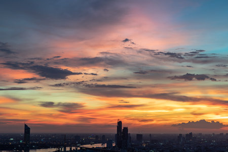 Beautiful sunset sky with dramatic light over large metropol city in Asia. Beautiful blazing sunset landscape, Copy space, No focus, specifically.のeditorial素材