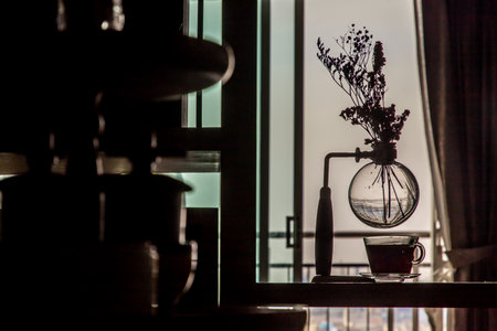 Still life decor details in the living room, A beautiful vase with dried flowers and coffee cup on wooden table. Selective focus.の写真素材