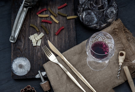 Flat lay composition with pitcher and glasses of red wine and corkscrew on wooden background :...