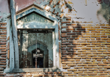 View through a window frame into an abandoned building was left to deteriorate over time....