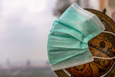 The globe is wearing a disposable medical mask. Concept of prevent spread of corona virus covid-19.の写真素材
