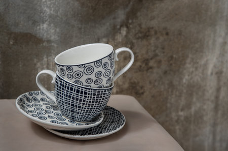 Two ceramics cups with coaster on pink table cloth. Ceramic tableware,  Beautiful arrangement, Copy...