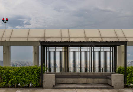 Relaxing furnished area on rooftop in warm summer day with the background of blue sky. Resting area.の写真素材