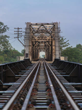 Old railroad tracks on Black Bridge or Lampang Railway Bridge. Railway bridge on river at Lampang thailand. Selective focus.の写真素材