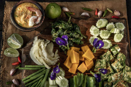 Thai Traditional Local Food : Shrimps chili dip or nam prik with shrimps (Nam Prik Goong Sod) with blanched vegetables and cha-om omelets on wooden backgroud.の写真素材