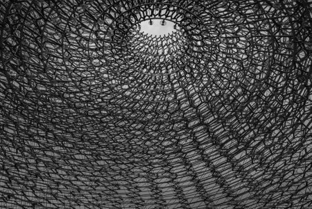 London, UK - Apr 9, 2019 : Detail on the center of the intricate structure under a clear sky, It is called "The Hive" Designed by Artist Wolfgang Buttress.のeditorial素材