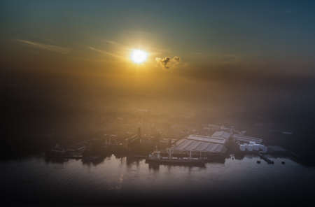 Bangkok, Thailand - Sep 29, 2021 : Aerial view overlooking beautiful scenery of cargo ship and industrial factory along Chao phraya river front in the morning. Selective focus.のeditorial素材