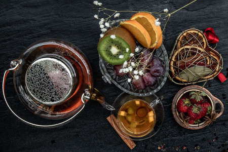Glass of freshly brewed fruit and herbal tea. Darker background. Top view.の写真素材