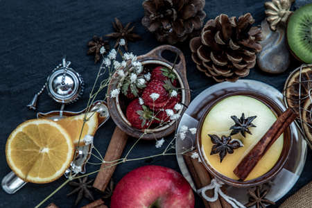 Glass of freshly brewed fruit and herbal tea. Darker background. Top view.の写真素材