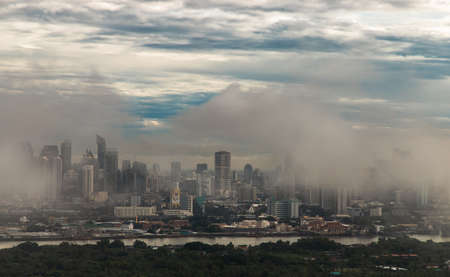 Bangkok, thailand -Aug 29, 2021 : An impressive aerial top view of skyscrapers at downtown Bangkok city along the chao phraya river in morning fog. No focus, specifically.のeditorial素材