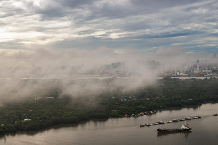 Bangkok, thailand -Aug 29, 2021 : An impressive aerial top view of skyscrapers at downtown Bangkok city along the chao phraya river in morning fog. No focus, specifically.のeditorial素材