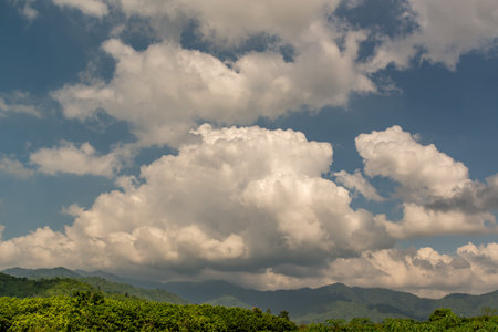 Green field and walkway in Thailand, Dramatic backdrop of Mountain and blue sky with clouds, Great...