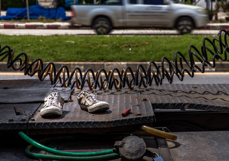 An old pair of dirty white sneakers shoe left on behind a truck. Symbolic way : the abandoned, No...