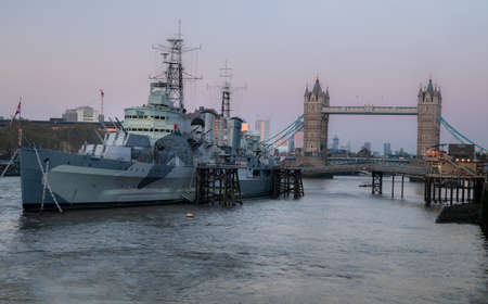 London, England - Apr 20, 2019 : HMS Belfast is a Town-class light cruiser that was built for the Royal Navy. She is now permanently moored as a museum ship in front of Tower Bridge on the River Thames, No focus, specifically.のeditorial素材