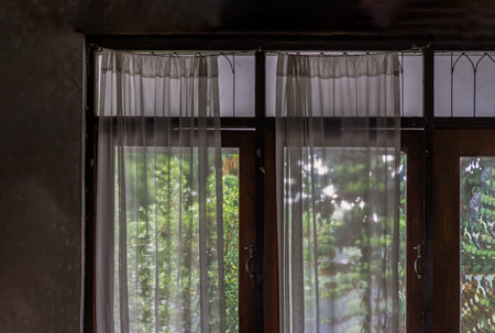 Wooden simple glass of Windows and White lace curtains with sunlight that shines through in traditional thai house, Thai Style architecture, No focus, specifically.の写真素材