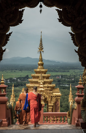 Lampang, Thailand - Sep 04, 2019 : Buddhist Monks are walking into down the gate of Wat Phra That...