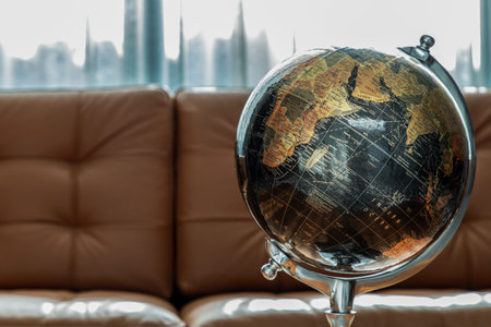 Chiang Rai,Thailand - Sep 06, 2020 : Replica globe on brown leather sofa and white curtains on background. Copy space. No focus, specifically.のeditorial素材