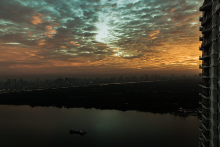 Bangkok, Thailand - Jan 04, 2022: Beautiful sunrise sky with cloud on the orange above clouds with...