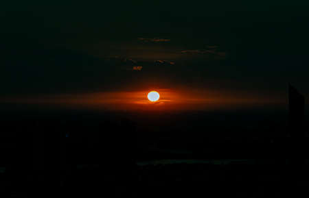 Scenic landscape moments before orange sunset sky over city skyline. Pattern for awesome nature background, Evening time, Selective focus.の写真素材