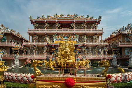 Chonburi, Thailand - 05 Feb 2022 : Architecture of chinese-style temple at Wihan Thep Sathit Phra Ki Ti Chaloem ( San Chao Na Cha or Naja Shrine) with a gilded fountain. Brightly colored statues & ornate pavilions, Selective focus.のeditorial素材