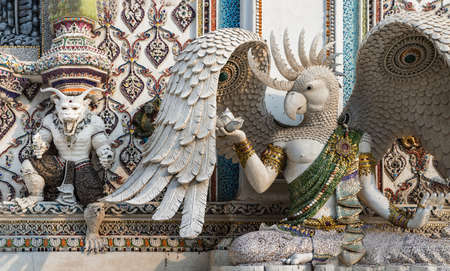 Bangkok, Thailand. Feb - 10, 2022 : Elaborate sculptures of monster is made of bricks and mortar, decorated with various colored glazed tiles at the chapel of The Pariwas Ratchasongkram temple. Selective Focus.のeditorial素材