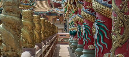 Chonburi, Thailand - 05 Feb 2022 :  Panoramic of  Sculptured dragons pillars and corridor in Chinese-style temple. Wihan Thep Sathit Phra Ki Ti Chaloem, Selective focus.のeditorial素材