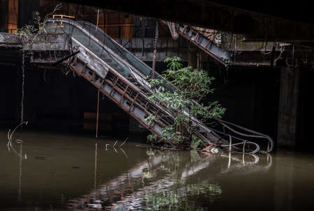 Bangkok, Thailand - 07 Feb 2022 : Damaged escalators and waterlogged in abandoned shopping mall building. Structural and ruins was left to deteriorate over time, New World Mall, Selective focus.のeditorial素材