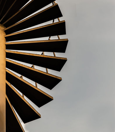 Brown metal spiral staircase pattern with iron railing for Decoration exterior on sky background....