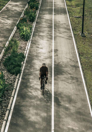 Bangkok, Thailand - Feb 19, 2022 : The cyclist riding a mountain bike an road along in a city park. One man bicycling along on the road, Selective focus.のeditorial素材