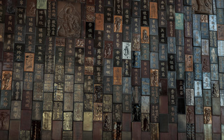 Bangkok, Thailand - Feb 19, 2022 : Chinese lettering teachings and Carved buddha images into a slab...