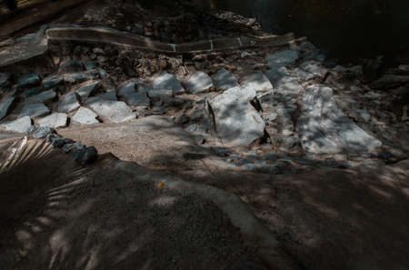 Sunbeams lighting down of stone slab at brookside. Abstract background texture, Beautiful background for wallpaper, Copy space, No focus, specifically.の写真素材