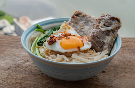 Thin rice noodles soup with Pork ribs, Fried egg and vegetable sprinkle with smoked shrimp paste...